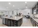 Open kitchen features a large island with granite countertop and stainless steel appliances at 8953 Hitch Creek St, Las Vegas, NV 89131