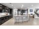 Contemporary kitchen with stainless steel appliances, a large island, and elegant finishes at 8953 Hitch Creek St, Las Vegas, NV 89131