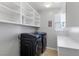 Modern laundry room featuring front load washer and dryer, white cabinets, and plenty of storage at 8953 Hitch Creek St, Las Vegas, NV 89131