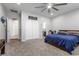 Large main bedroom with neutral walls, modern ceiling fan, and sliding closet doors at 8953 Hitch Creek St, Las Vegas, NV 89131