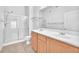 Bright bathroom featuring dual sinks, a glass shower, and tile floors at 8985 S Durango Dr # 1110, Las Vegas, NV 89113