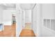 Hallway with hardwood floors leading to closet with white shelves at 8985 S Durango Dr # 1110, Las Vegas, NV 89113