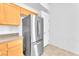 Kitchen features stainless steel refrigerator with oak colored cabinets at 8985 S Durango Dr # 1110, Las Vegas, NV 89113