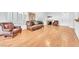 Open-concept living room with hardwood floors, large windows, and sofa seating at 8985 S Durango Dr # 1110, Las Vegas, NV 89113