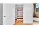 Spacious walk-in closet with custom shelving and wood flooring at 8985 S Durango Dr # 1110, Las Vegas, NV 89113
