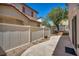 Backyard with white fence and partial view of trees at 9165 Starling Wing Pl, Las Vegas, NV 89143