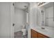 Bathroom with oak vanity, ample lighting, and tile flooring at 9165 Starling Wing Pl, Las Vegas, NV 89143