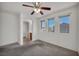 Neutral bedroom with ensuite bath, carpet flooring, and a ceiling fan at 9165 Starling Wing Pl, Las Vegas, NV 89143