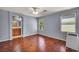 A bedroom has wood floors, two windows and an entry to an ensuite bathroom at 9165 Starling Wing Pl, Las Vegas, NV 89143