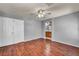 A bedroom with hardwood floors leads to an ensuite bathroom and large closet at 9165 Starling Wing Pl, Las Vegas, NV 89143
