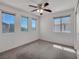 Bright bedroom with ample natural light, ceiling fan, and neutral carpet at 9165 Starling Wing Pl, Las Vegas, NV 89143