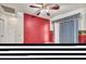 Bonus room with red wall, chicken-themed wallpaper, blue curtains and door to another room at 9165 Starling Wing Pl, Las Vegas, NV 89143