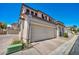 Exterior view of home showing two-car garage and front entrance at 9165 Starling Wing Pl, Las Vegas, NV 89143
