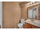 Half bathroom showing sink, toilet, mirror, tile flooring and neutral wall color at 9165 Starling Wing Pl, Las Vegas, NV 89143