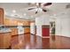 Bright kitchen boasting wood cabinets, granite countertops, white appliances, and hardwood floors at 9165 Starling Wing Pl, Las Vegas, NV 89143