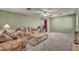 Spacious living room featuring a floral sofa, chair, ceiling fan, and view to stairs at 9165 Starling Wing Pl, Las Vegas, NV 89143