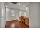 A hardwood floor office space featuring a built-in desk, storage cabinets, and natural light at 9165 Starling Wing Pl, Las Vegas, NV 89143