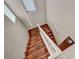 A carpeted staircase with white railing receives ample light from a skylight above, leading to the upper level at 9165 Starling Wing Pl, Las Vegas, NV 89143