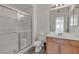 Bathroom featuring a glass enclosed shower, modern fixtures, and wooden vanity at 9330 W Maule Ave # 212, Las Vegas, NV 89148
