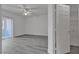 Bedroom with gray floors, ceiling fan, and sliding glass doors to balcony at 9330 W Maule Ave # 212, Las Vegas, NV 89148