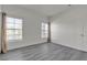 Bright bedroom features gray floors, white walls, and two windows with neutral drapes at 9330 W Maule Ave # 212, Las Vegas, NV 89148