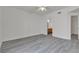 Bright bedroom with ceiling fan, grey wood-look flooring, and bathroom access at 9330 W Maule Ave # 212, Las Vegas, NV 89148