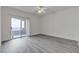 Bedroom with gray wood-look flooring and access to a balcony at 9330 W Maule Ave # 212, Las Vegas, NV 89148