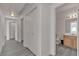 Hallway featuring gray floors, white walls, and doorways to other rooms at 9330 W Maule Ave # 212, Las Vegas, NV 89148
