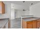 Bright kitchen featuring wooden cabinets, gray countertops, and a view into the living area at 9330 W Maule Ave # 212, Las Vegas, NV 89148