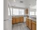 Bright kitchen featuring wooden cabinets, white appliances, gray countertops, and a window over the sink at 9330 W Maule Ave # 212, Las Vegas, NV 89148