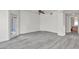 Bright living room featuring gray wood flooring, a ceiling fan, and access to outdoor space at 9330 W Maule Ave # 212, Las Vegas, NV 89148