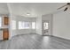 Inviting living room with large windows, gray flooring, and a glimpse of the kitchen at 9330 W Maule Ave # 212, Las Vegas, NV 89148