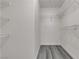 Spacious walk-in closet with wood-look floors and multiple tiers of wire shelving for optimal storage at 9330 W Maule Ave # 212, Las Vegas, NV 89148