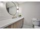 Modern bathroom with sleek vanity, stylish fixtures, and a round mirror at 9340 W Washburn Rd, Las Vegas, NV 89149