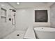 Contemporary bathroom with a soaker tub and walk-in shower with black fixtures at 9340 W Washburn Rd, Las Vegas, NV 89149