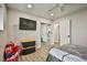 Cozy bedroom with a wall mounted tv, mirrored closet, and modern ceiling fan at 9340 W Washburn Rd, Las Vegas, NV 89149