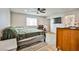 Comfortable bedroom featuring an accent rug, ceiling fan, and attached bathroom at 9340 W Washburn Rd, Las Vegas, NV 89149
