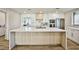 Modern kitchen with white cabinets, quartz countertops, stainless steel appliances, and a large central island at 9340 W Washburn Rd, Las Vegas, NV 89149