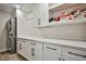Well-organized laundry room with modern cabinetry, ample counter space, and a stacked washer/dryer at 9340 W Washburn Rd, Las Vegas, NV 89149