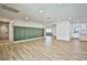 Large living area featuring sleek wood flooring and a modern accent wall at 9340 W Washburn Rd, Las Vegas, NV 89149