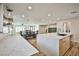Open-concept living space with a modern kitchen featuring quartz countertops and stainless steel appliances, connected to the dining area at 9340 W Washburn Rd, Las Vegas, NV 89149
