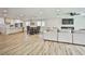 Spacious open-concept living area with a modern kitchen, dining space, living room, and lots of natural light at 9340 W Washburn Rd, Las Vegas, NV 89149