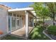 Inviting backyard with covered patio, manicured lawn, and mature trees offering shade at 9404 Calico Garden Ave, Las Vegas, NV 89134