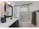 Bathroom featuring a shower-tub combo with floral curtain and a single sink vanity at 9404 Calico Garden Ave, Las Vegas, NV 89134