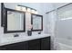 Primary bathroom featuring dual sinks, a tub-shower combo, and modern lighting fixtures at 9404 Calico Garden Ave, Las Vegas, NV 89134