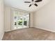 Bright bedroom with a ceiling fan and a glass door leading to the backyard at 9404 Calico Garden Ave, Las Vegas, NV 89134