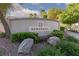 Landscaped entrance to the Serenata community featuring lush greenery and decorative rocks at 9404 Calico Garden Ave, Las Vegas, NV 89134