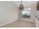 Traditional dining room with decorative chandelier and view of exterior garden at 9404 Calico Garden Ave, Las Vegas, NV 89134