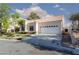 Inviting single-story home featuring a two-car garage, tile roof, and well-kept landscaping for curb appeal at 9404 Calico Garden Ave, Las Vegas, NV 89134