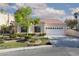Charming single-story home with a tile roof, manicured lawn, and attached two-car garage at 9404 Calico Garden Ave, Las Vegas, NV 89134